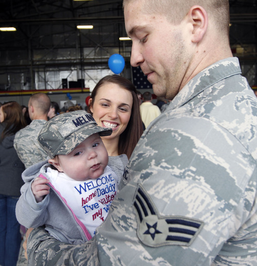 Al Hartmann  |  The Salt Lake Tribune
Airman Joe Crawford holds his 4-month-old daughter Melina for the first time as his wife Amanda greets him on his return to HIll Air Force Base Monday. He was among the 150 airmen from the 388th Fighter Wing returning from a six-month deployment to Kunsan Air Base, Republic of Korea. The pilots and maintenance and support crews provided F-16 air support in the region as part of a routine U.S. Pacific Command's Theater Security Package rotation.